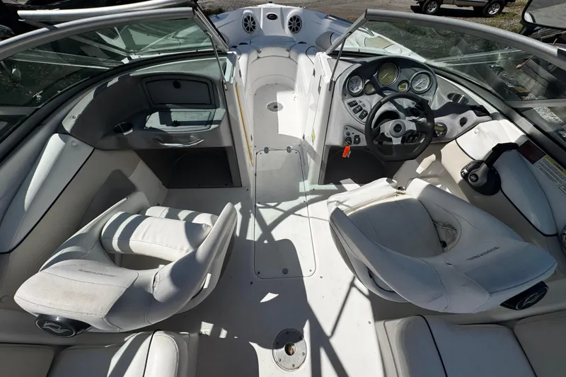 Slide: The Image of 2008 Rinker 226 Captiva Bowrider interior with white seating and modern dashboard controls. - 6