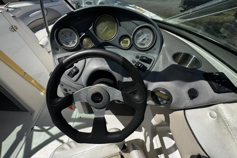 Slide: The Image of 2008 Rinker 226 Captiva Bowrider dashboard with steering wheel and gauges. - 7