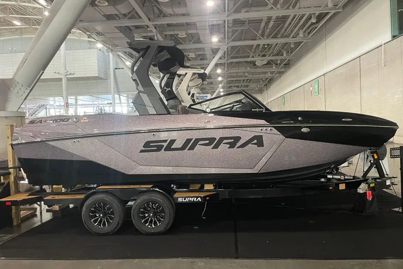 The Image of 2025 Supra SA boat on display, sleek design with modern features, showcased indoors. - 0