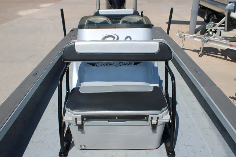 Slide: The Image of 2023 Mamba 24VX boat on trailer, parked outdoors under clear sky. - 1