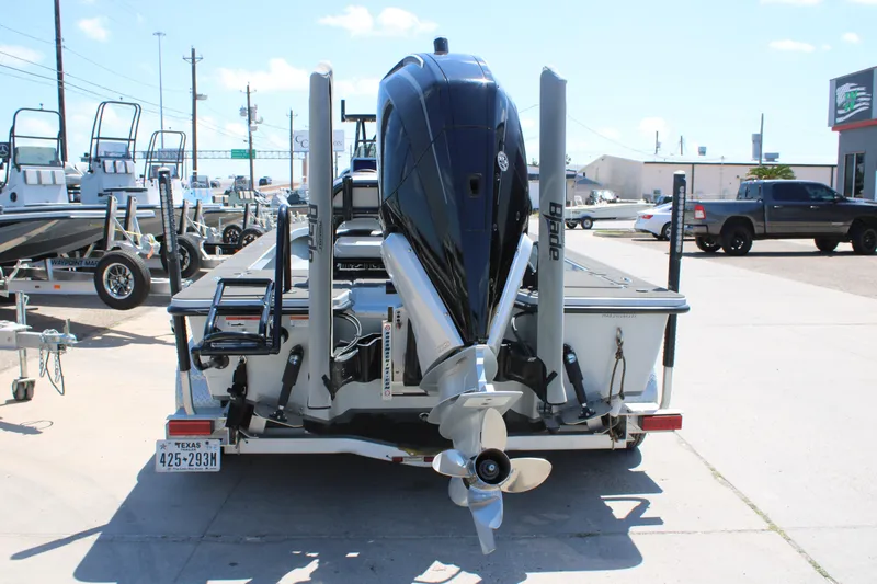 Slide: The Image of 2023 Mamba 24VX boat with powerful engine on trailer, parked outside dealership. - 11