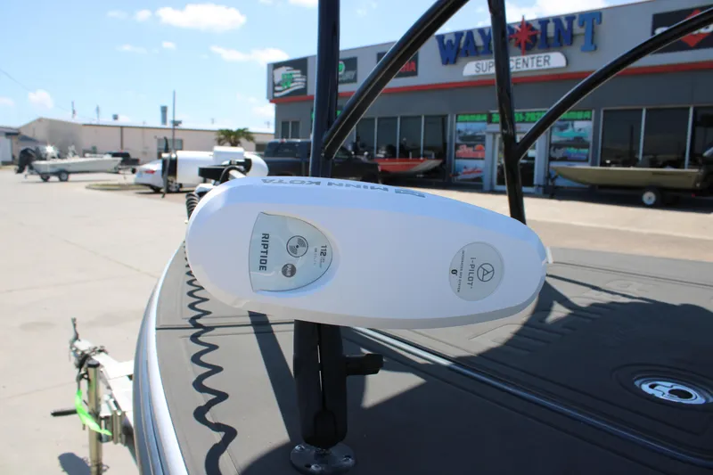 Slide: The Image of 2023 Mamba 24VX boat with seating and storage, parked outdoors under a clear sky. - 15