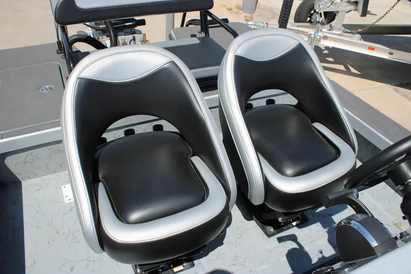 Slide: The Image of 2023 Mamba 24VX boat on trailer, featuring Minn Kota Terrova motor, parked outdoors. - 2