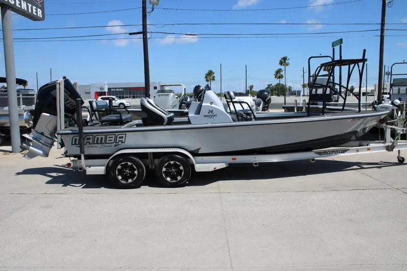 Slide: The Image of 2023 Mamba 24VX boat with powerful outboard motor in a parking area. - 9