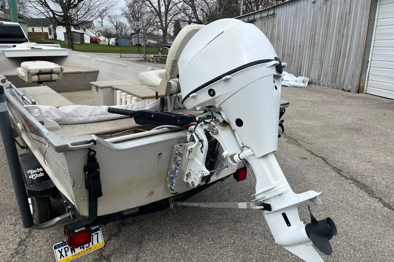 Slide: The Image of 2004 Sylvan 1600 Super Snapper boat with outboard motor, parked on a trailer. - 3