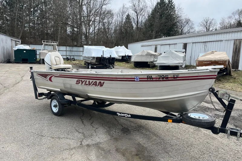 Slide: The Image of 2004 Sylvan 1600 Super Snapper boat on trailer in outdoor storage area. - 6