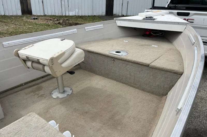 Slide: The Image of 2004 Sylvan 1600 Super Snapper boat interior with seating and storage compartments. - 7