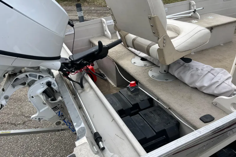 Slide: The Image of 2004 Sylvan 1600 Super Snapper boat interior with motor and seating. - 9