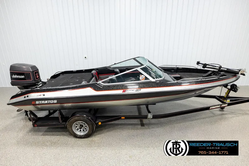 The Image of 1992 Stratos 290 Ski-N-Fish boat with Johnson outboard motor on trailer. - 1