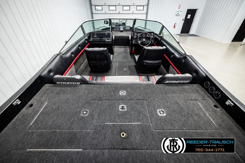 Slide: The Image of 1992 Stratos 290 Ski-N-Fish boat interior with seating and dashboard, in showroom. - 11