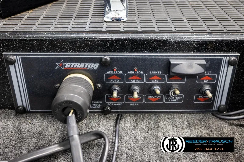 Slide: The Image of Control panel of a 1992 Stratos 290 Ski-N-Fish boat with various switches and dials. - 22
