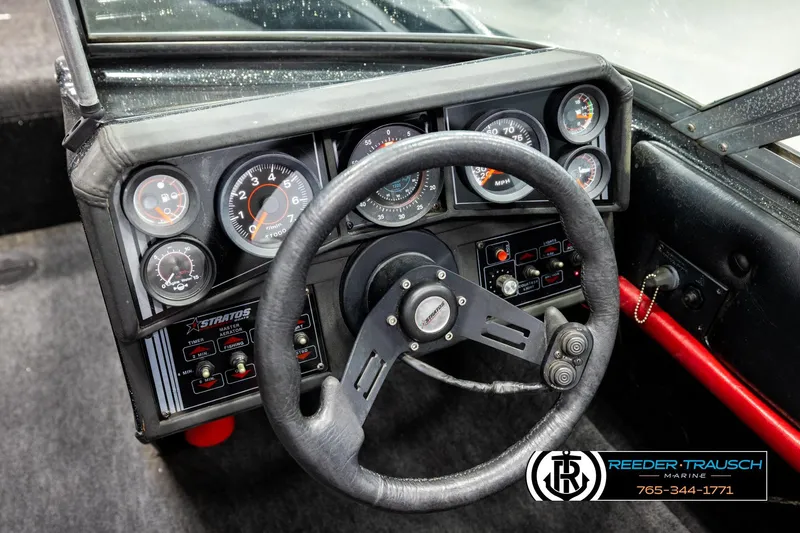 Slide: The Image of Dashboard of a 1992 Stratos 290 Ski-N-Fish boat with gauges and steering wheel. - 25