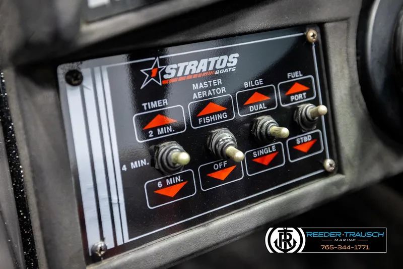 Slide: The Image of Control panel of a 1992 Stratos 290 Ski-N-Fish boat with switches and labels. - 27