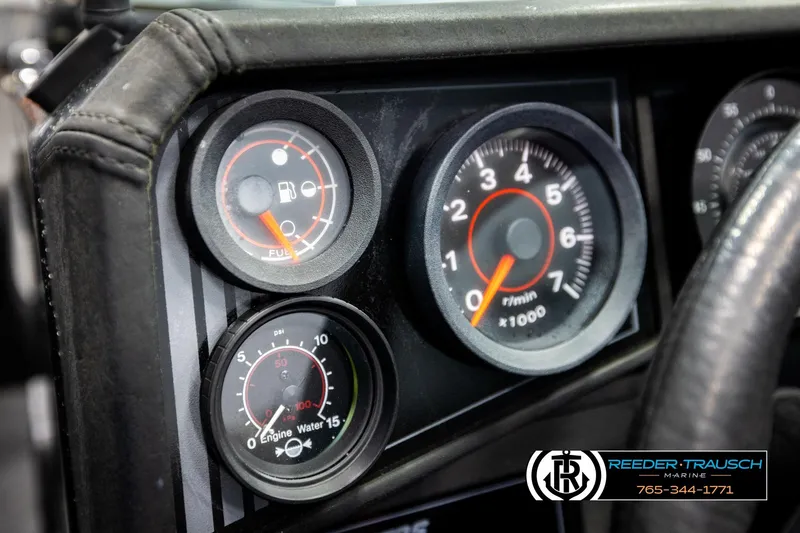 Slide: The Image of Dashboard gauges of a 1992 Stratos 290 Ski-N-Fish boat, featuring fuel and RPM indicators. - 28