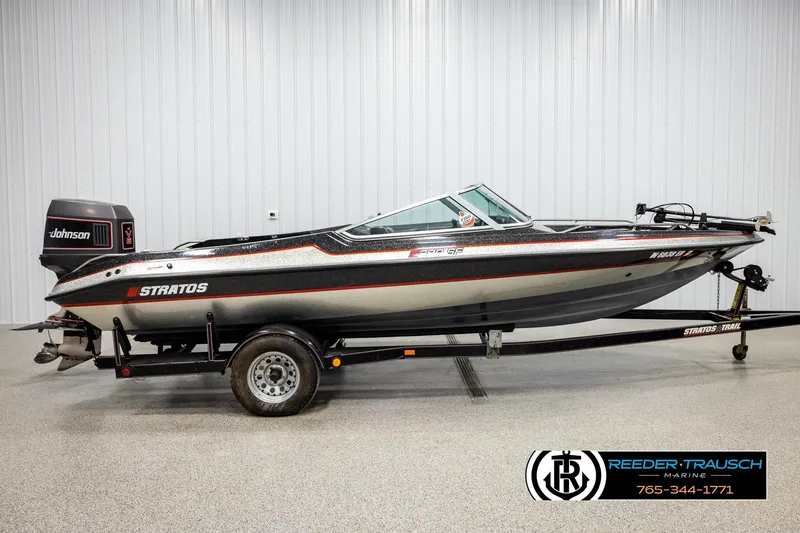 Slide: The Image of 1992 Stratos 290 Ski-N-Fish boat with Johnson motor on trailer, indoor display. - 3