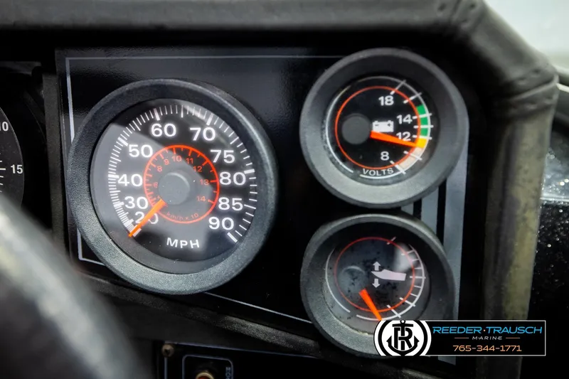 Slide: The Image of Dashboard gauges of a 1992 Stratos 290 Ski-N-Fish boat, showing speedometer and voltmeter. - 30