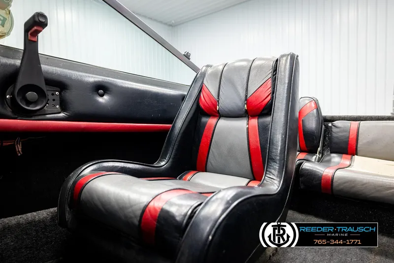 Slide: The Image of Interior of a 1992 Stratos 290 Ski-N-Fish boat with black and red seating. - 33
