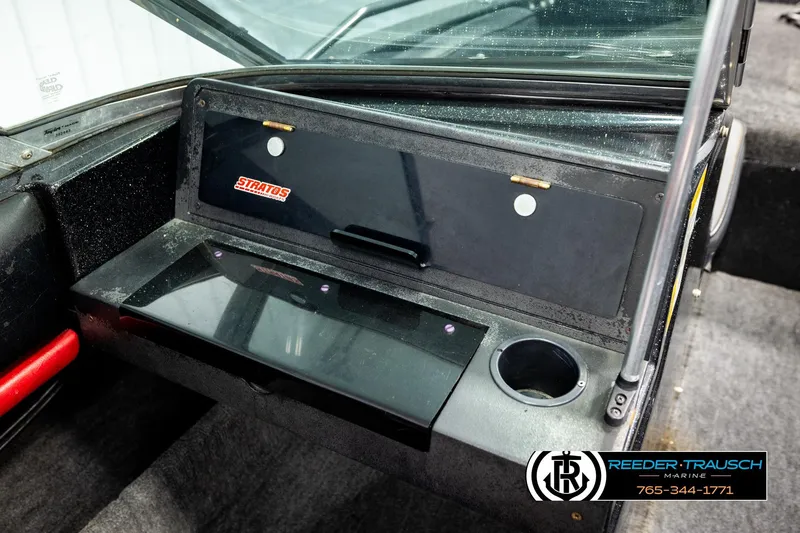 Slide: The Image of 1992 Stratos 290 Ski-N-Fish boat dashboard with storage compartment and cup holder. - 36