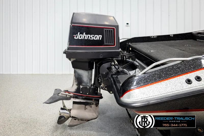 Slide: The Image of 1992 Stratos 290 Ski-N-Fish boat with Johnson outboard motor in showroom. - 37