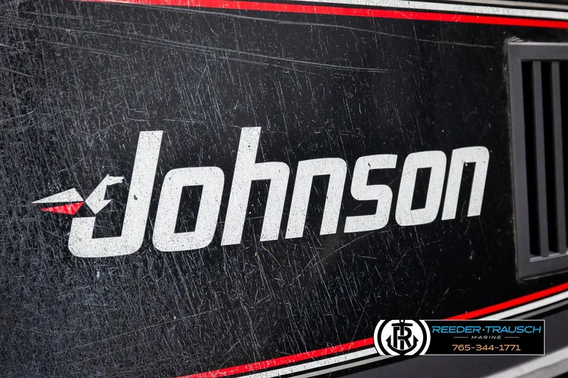 Slide: The Image of Johnson logo on a 1992 Stratos 290 Ski-N-Fish boat with visible wear. - 38