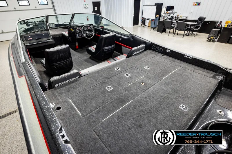 Slide: The Image of 1992 Stratos 290 Ski-N-Fish boat interior with seating and dashboard in showroom. - 9
