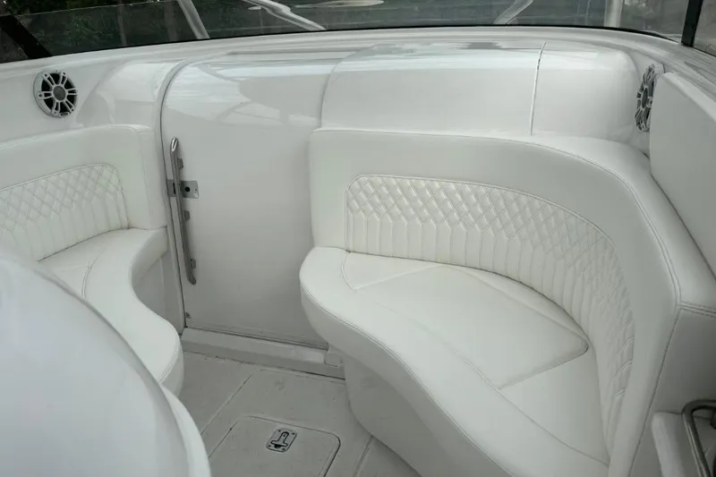 Slide: The Image of White leather seating on a 2004 Donzi 38 ZSF boat interior. - 10