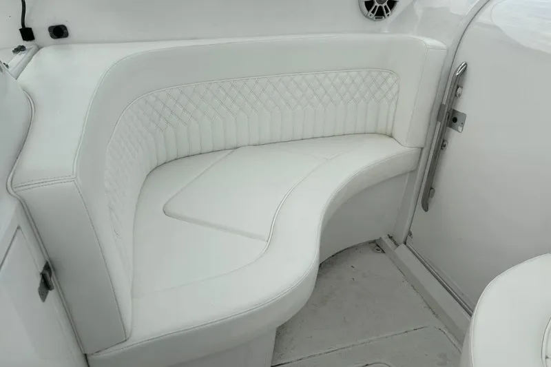 Slide: The Image of White leather seating on a 2004 Donzi 38 ZSF boat, featuring diamond stitching. - 11