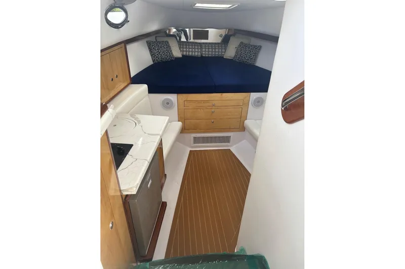Slide: The Image of Interior of 2004 Donzi 38 ZSF boat with cozy cabin and kitchenette. - 12
