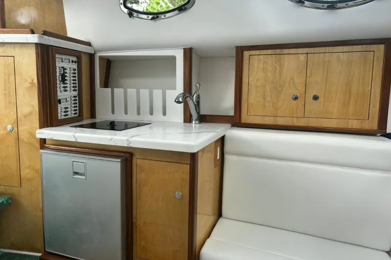 Slide: The Image of Interior of 2004 Donzi 38 ZSF boat with kitchenette and seating area. - 14