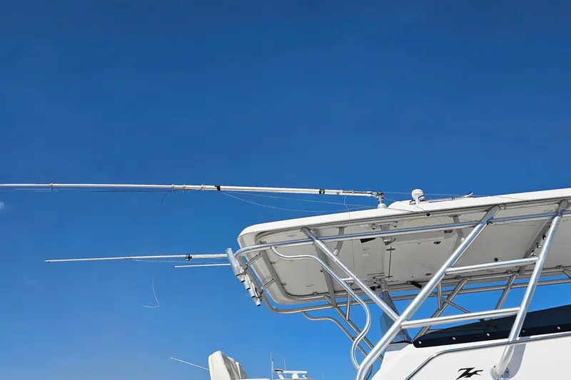 Slide: The Image of 2004 Donzi 38 ZSF boat with fishing rods against a clear blue sky. - 17