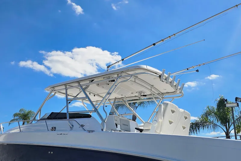Slide: The Image of 2004 Donzi 38 ZSF boat with fishing rods, under a clear blue sky. - 21