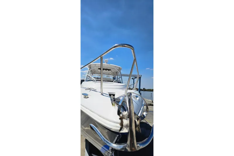 Slide: The Image of 2004 Donzi 38 ZSF boat docked under clear blue sky. - 23