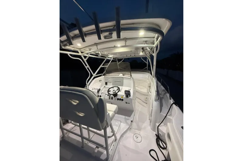 Slide: The Image of 2004 Donzi 38 ZSF boat cockpit with illuminated controls and seating at night. - 24