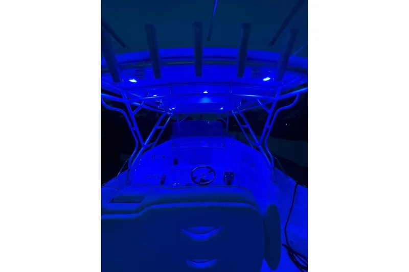 Slide: The Image of 2004 Donzi 38 ZSF boat interior illuminated with blue LED lights at night. - 25