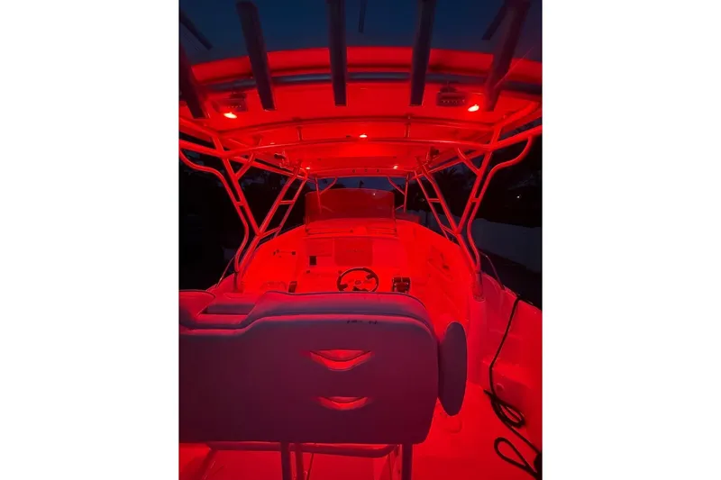 Slide: The Image of 2004 Donzi 38 ZSF boat interior illuminated with red lighting at night. - 26
