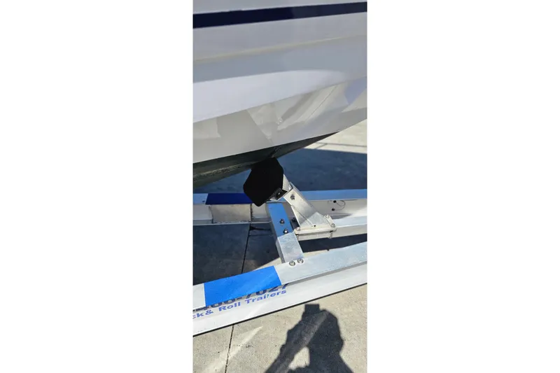 Slide: The Image of 2004 Donzi 38 ZSF boat on trailer, close-up of hull and support bracket. - 28