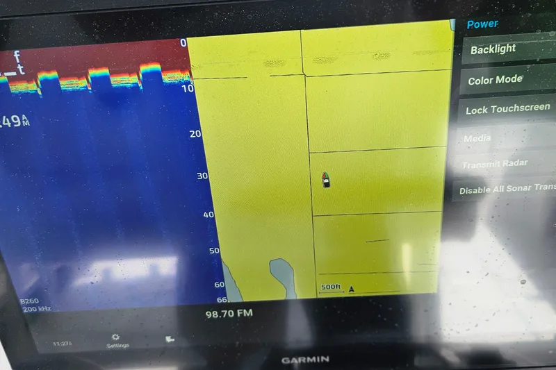 Slide: The Image of Garmin marine navigation display on a 2004 Donzi 38 ZSF boat, showing sonar and map data. - 31