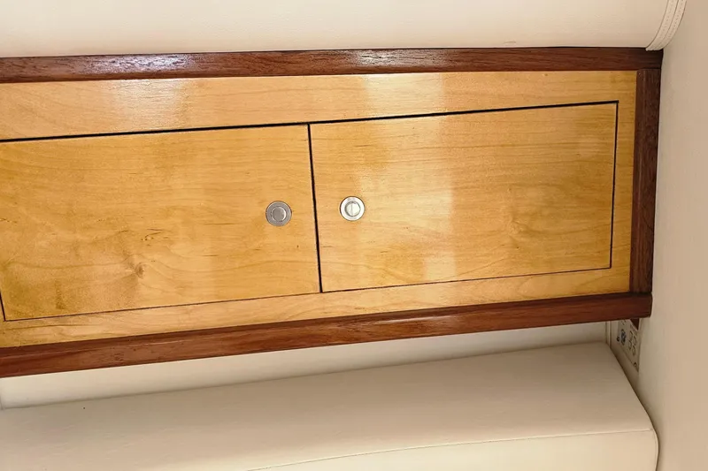 Slide: The Image of Wooden cabinet doors inside a 2004 Donzi 38 ZSF boat, featuring sleek metal handles. - 34