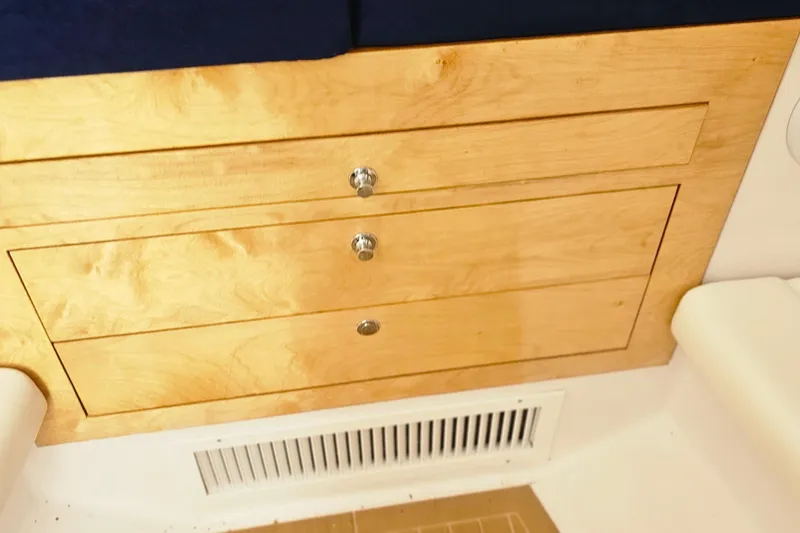 Slide: The Image of Wooden drawers inside a 2004 Donzi 38 ZSF boat, featuring sleek metal handles. - 35