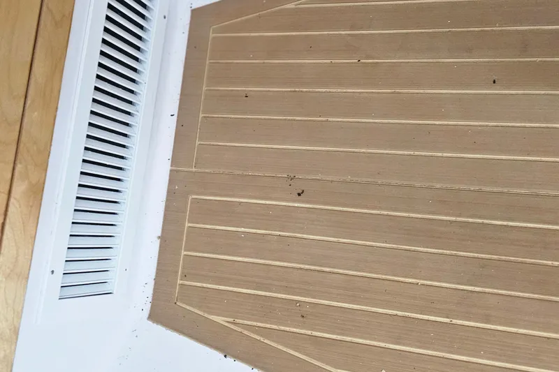 Slide: The Image of Teak deck flooring of a 2004 Donzi 38 ZSF boat near a white vent. - 36