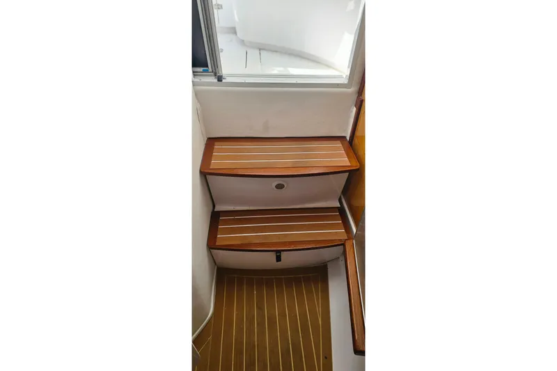 Slide: The Image of Wooden steps inside a 2004 Donzi 38 ZSF boat, featuring sleek design and craftsmanship. - 37