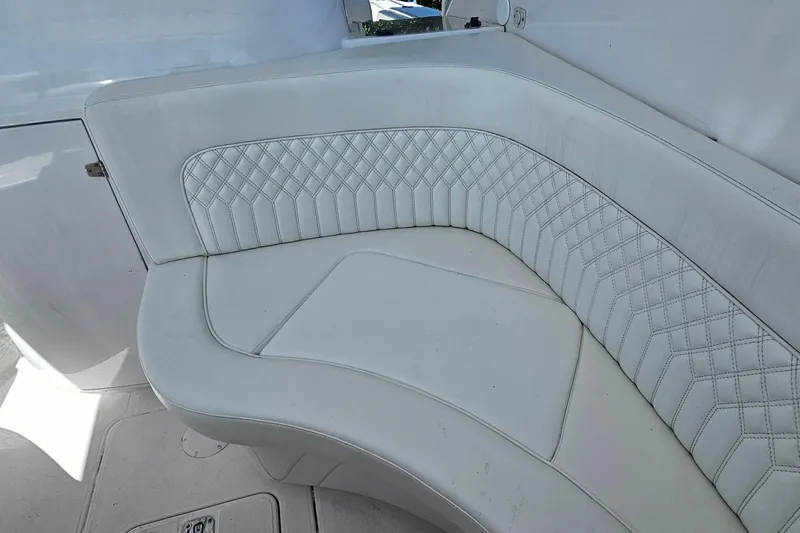 Slide: The Image of White leather seating on a 2004 Donzi 38 ZSF boat, featuring diamond stitching. - 38