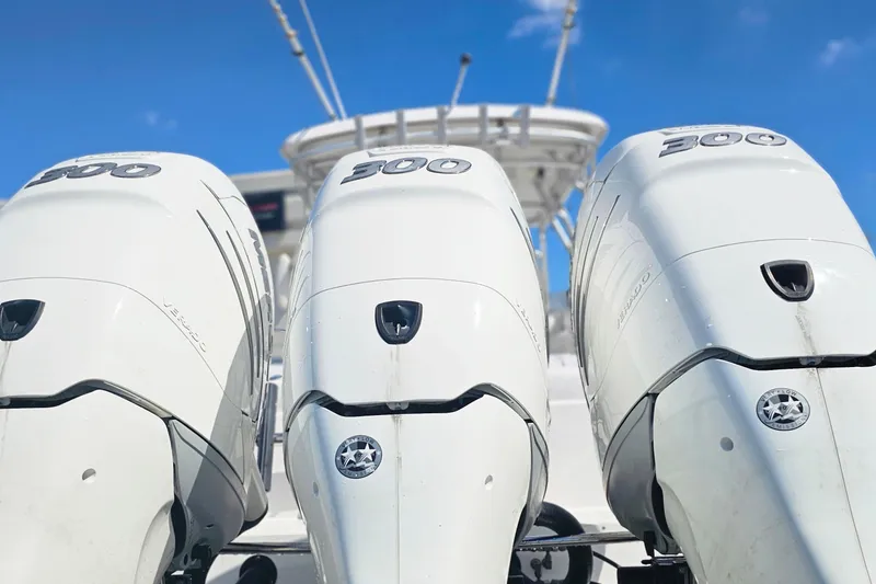 Slide: The Image of Triple outboard engines on a 2004 Donzi 38 ZSF boat against a clear blue sky. - 4