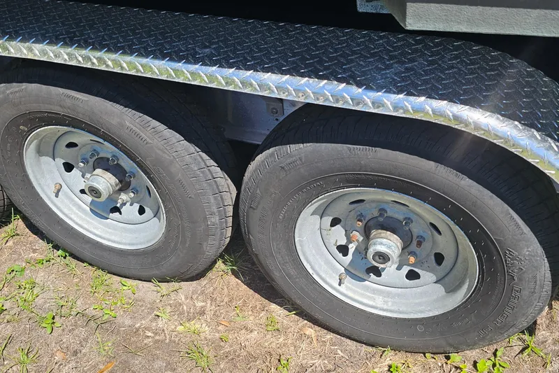 Slide: The Image of Trailer wheels for 2004 Donzi 38 ZSF boat, featuring dual tires and diamond plate fender. - 40