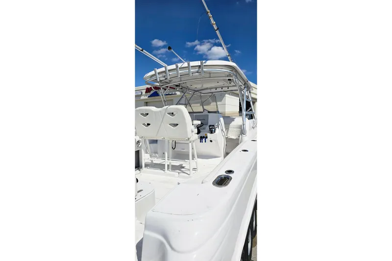 Slide: The Image of 2004 Donzi 38 ZSF boat interior with white seating and fishing rod holders. - 5