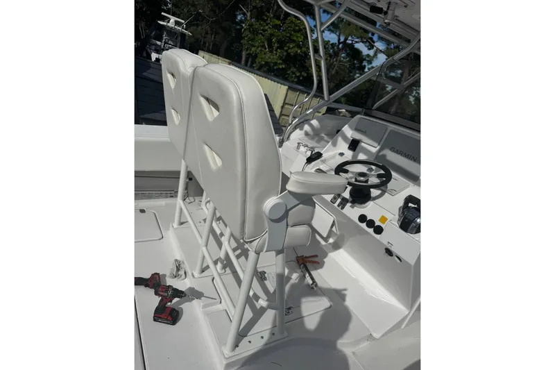 Slide: The Image of 2004 Donzi 38 ZSF boat cockpit with white seats and steering wheel. - 6