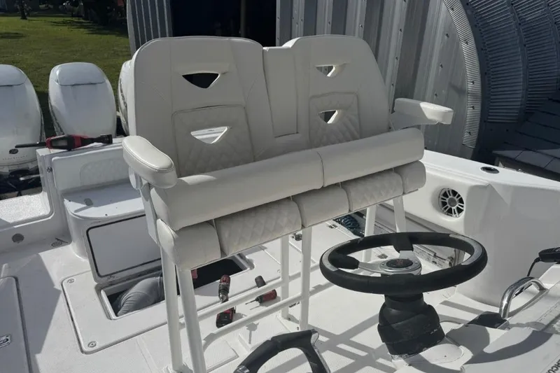 Slide: The Image of 2004 Donzi 38 ZSF boat interior with white seating and steering wheel. - 8