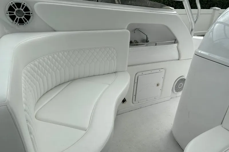 Slide: The Image of 2004 Donzi 38 ZSF boat interior with white seating and built-in sink. - 9