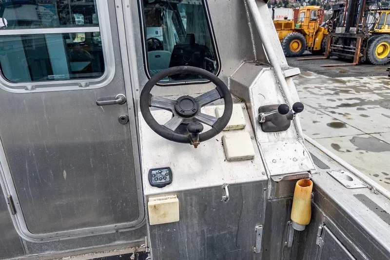 Slide: The Image of 2003 Lifetimer 3050 Pleasure Cabin boat cockpit with steering wheel and controls. - 10