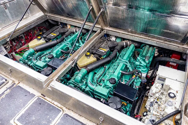 Slide: The Image of Engine compartment of a 2003 Lifetimer 3050 Pleasure Cabin boat, showcasing dual engines. - 14